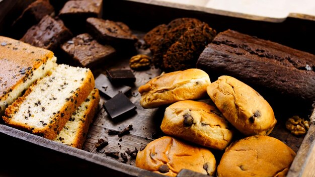 Different kinds of cakes arranged on a wooden tray