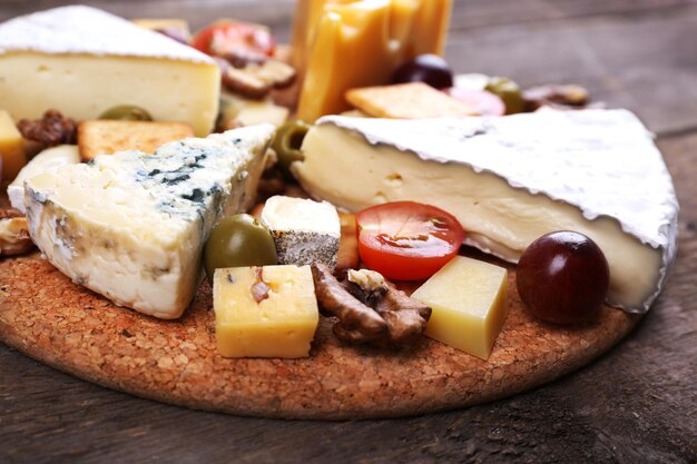 Different kinds of cheese on wooden background