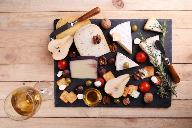 Different kinds of cheese on wooden