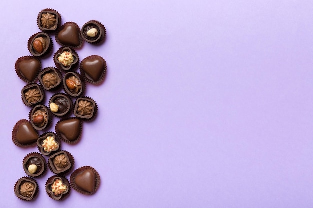 Different kinds of chocolates on colored table closeup Top View and Flat Lay with copy space