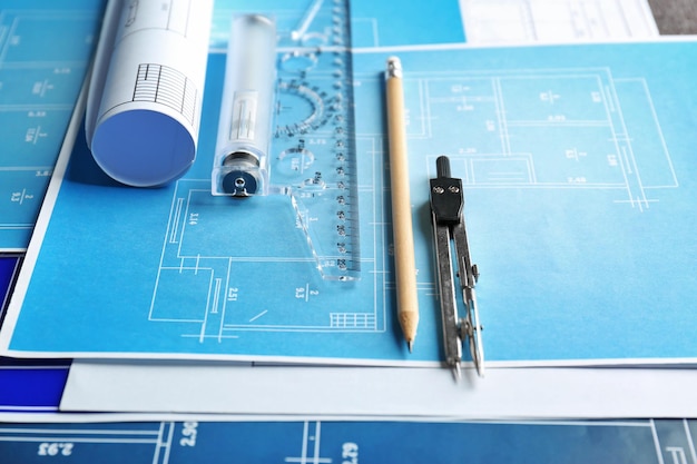 Different kinds of engineering tools on construction drawings background