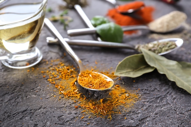 Different kinds of spices on grey table