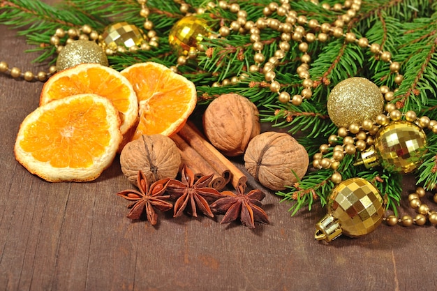 Different kinds of spices nuts and dried oranges Christmas decorations and spruse branch