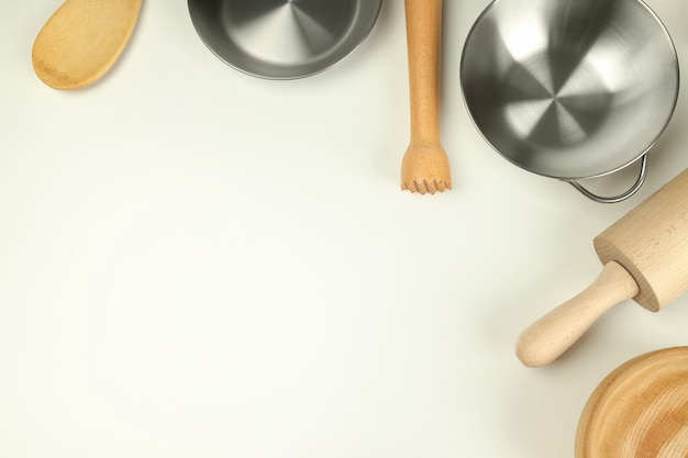 Different kitchen utensil on white background, top view.