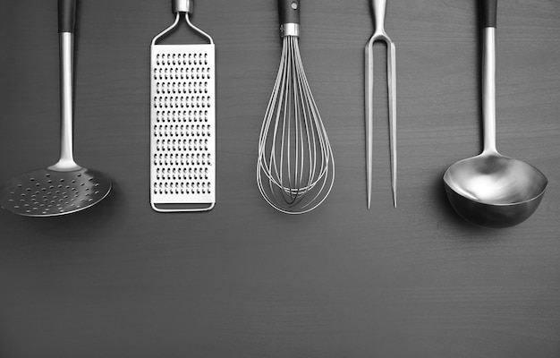 Different kitchen utensils on grey background