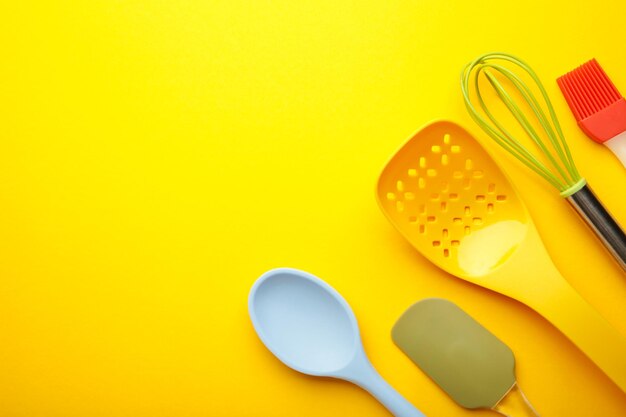 Different kitchenware on a yellow background top view cooking appliances
