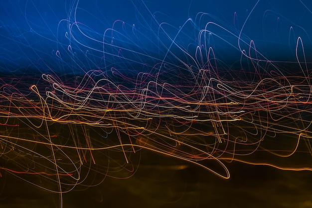 Different light painting photography color abstractions of light curves and waves of neon light against black background