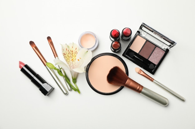 Different makeup cosmetics on white background