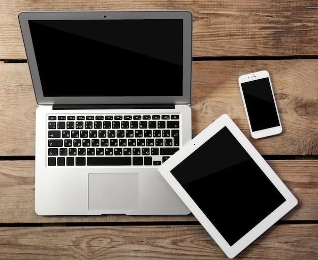 different modern devices on wooden table