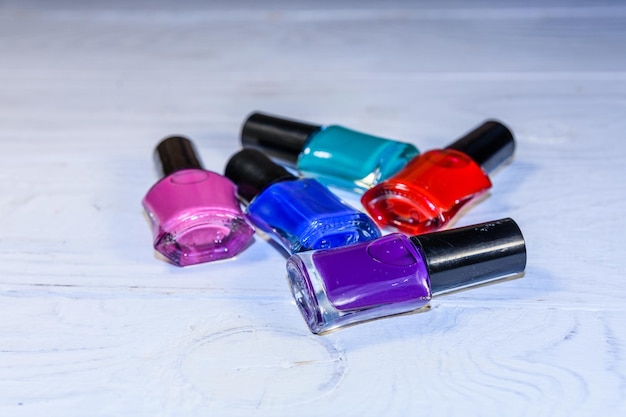 Different nail polishes on a wooden table