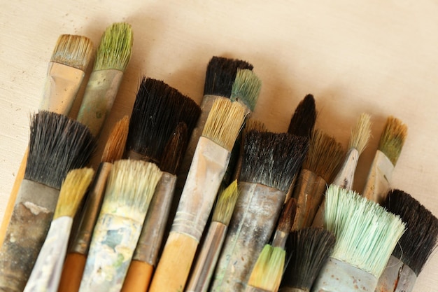 Photo different paintbrushes on fabric background