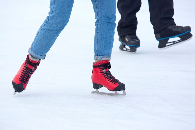 different people are actively skating on an ice rink