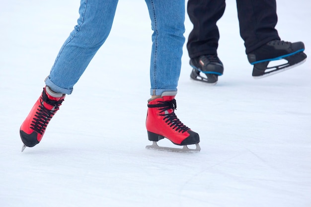 Different people are actively skating on an ice rink