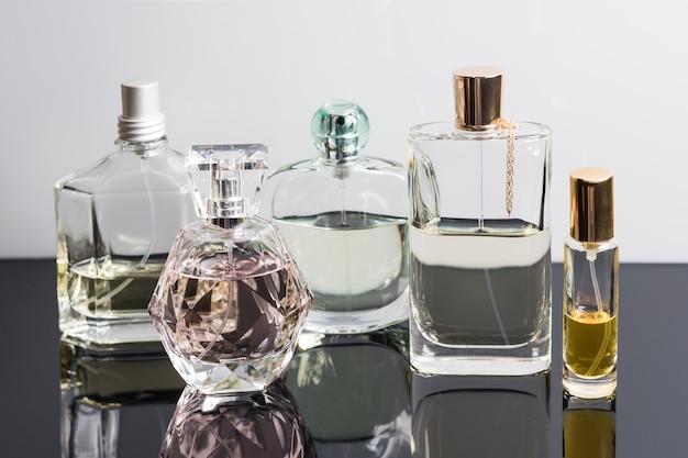 Different perfume bottles with reflections