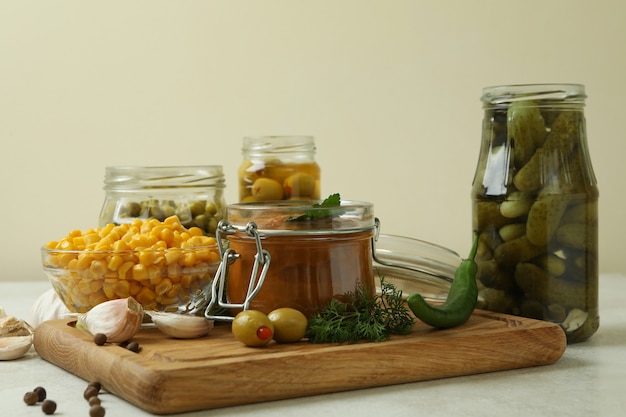 Different pickled food and ingredients on white textured table