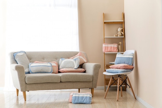 Photo different pillows on chair in room