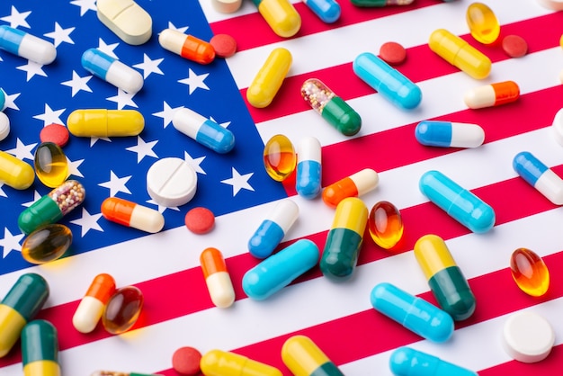 Different pills and tablets on flag of US