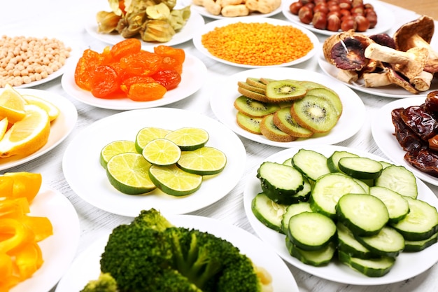 Different products on saucers on wooden table