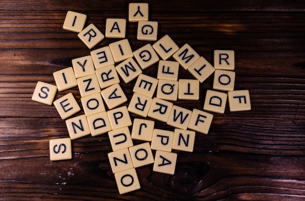 Different random letters on rustic wooden table