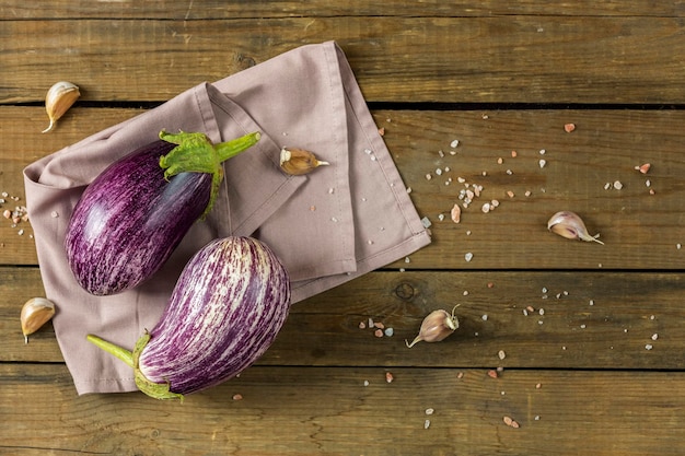 Different raw fresh eggplant on dark wooden background Concept of green house life style and products of subsistence farming flat lay copy space