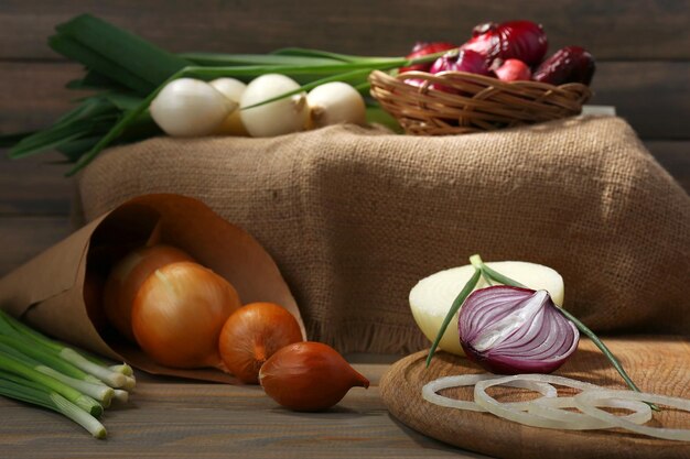 Different raw onion on wooden background