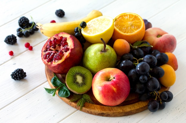 Different ripe fruits on a wooden board