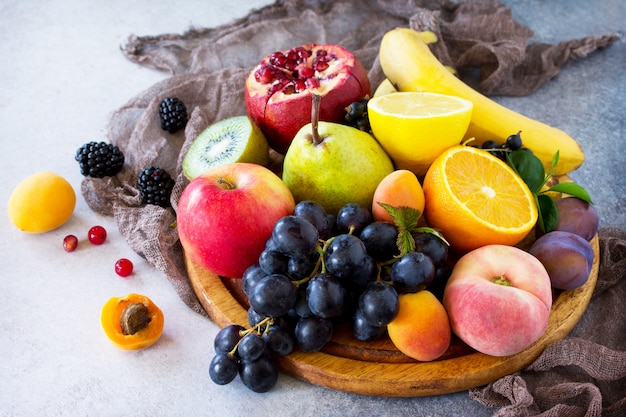 Different ripe fruits on a wooden board