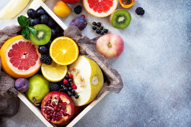 Different ripe fruits in a wooden box