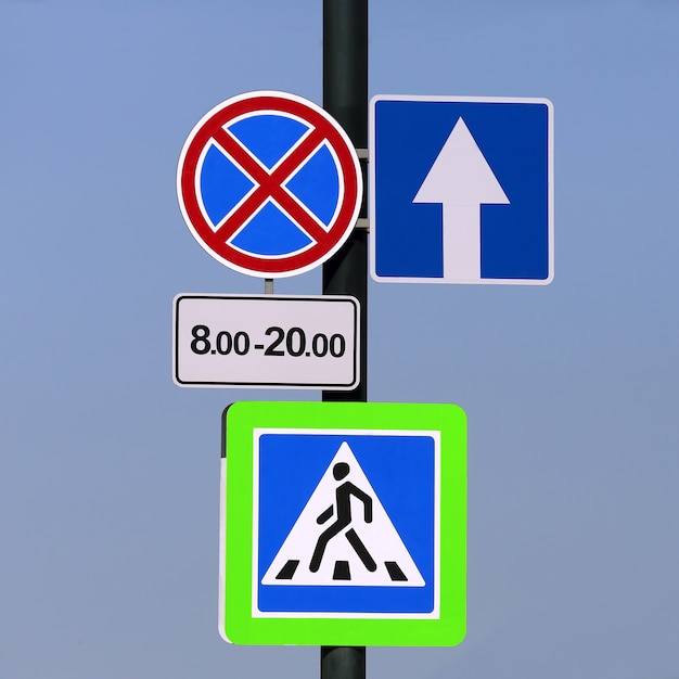 Different road signs on a pole