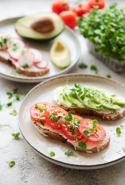 Different sandwiches with vegetables and microgreens