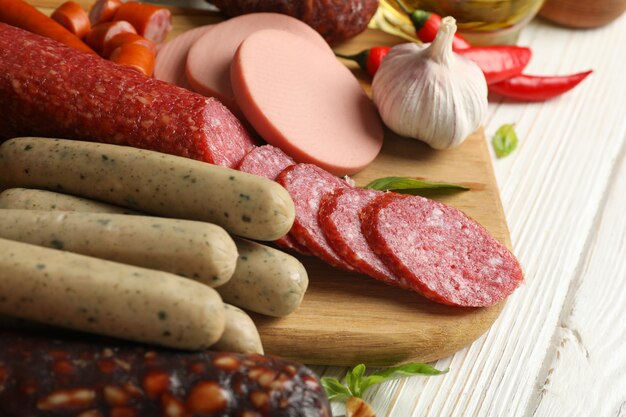 Different sausages and spices on wooden