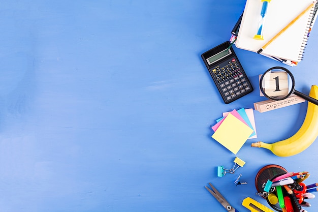 Different school supplies on blue background. Concept Back to school