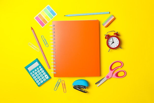 Different school supplies on yellow