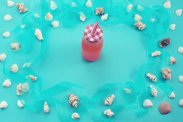 Different sea shells on blue background Top view flat lay