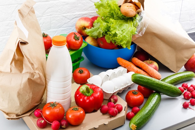 Different set of products to order in paper bags on white background