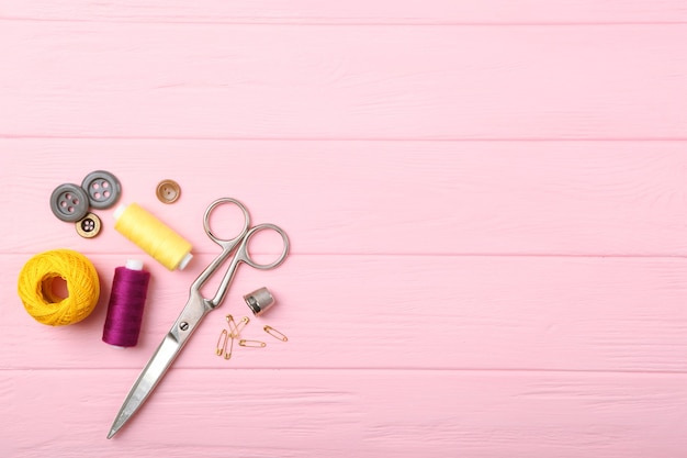 Different sewing accessories on the table closeup