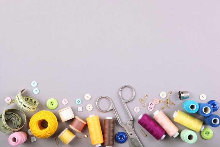 Photo different sewing accessories on the table closeup