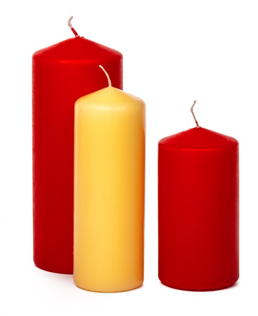 Different size and colors candles isolated on a white  