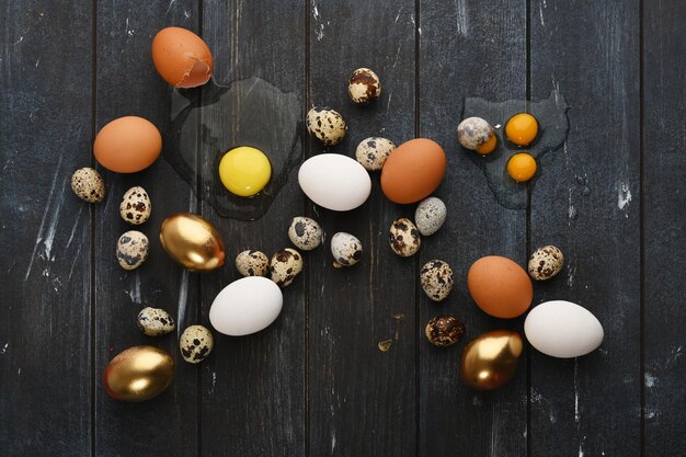 Different size quail and chicken eggs on a wooden surface Horizontal