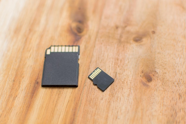 Different sizes of memory cards on a wooden background