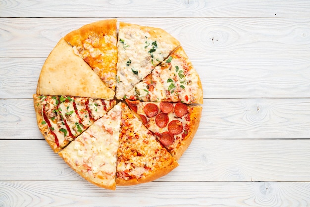 Different slices of pizza in one circle, flat lay