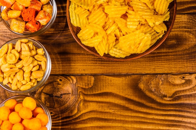 Different snacks for beer on wooden table Top view