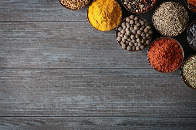 Different spices in bowls on table