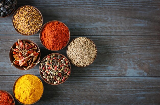 Different spices in bowls on table