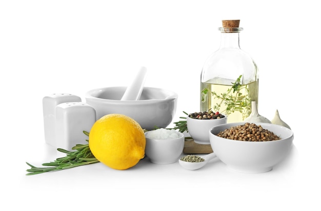 Different spices and kitchenware on white background