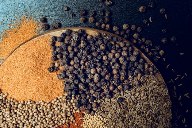 Different spices on a wooden board