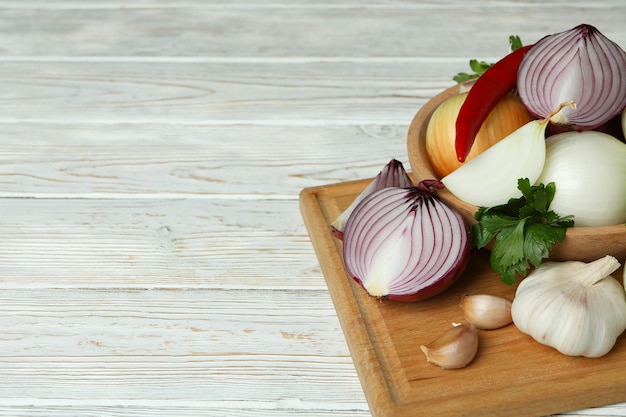 Different spicy vegetables on white wooden background