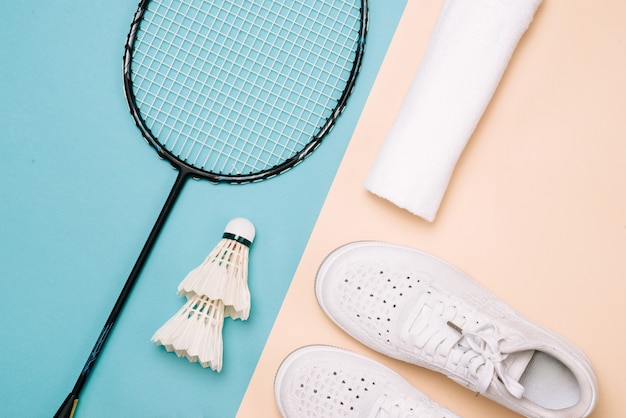 Different sports equipment on pastel color surface