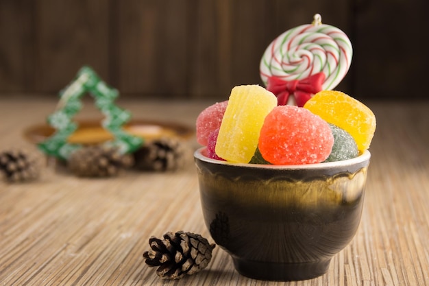 Different sweet candies on rustic wooden table