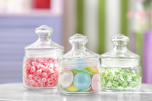 Different sweets in jars at candy shop